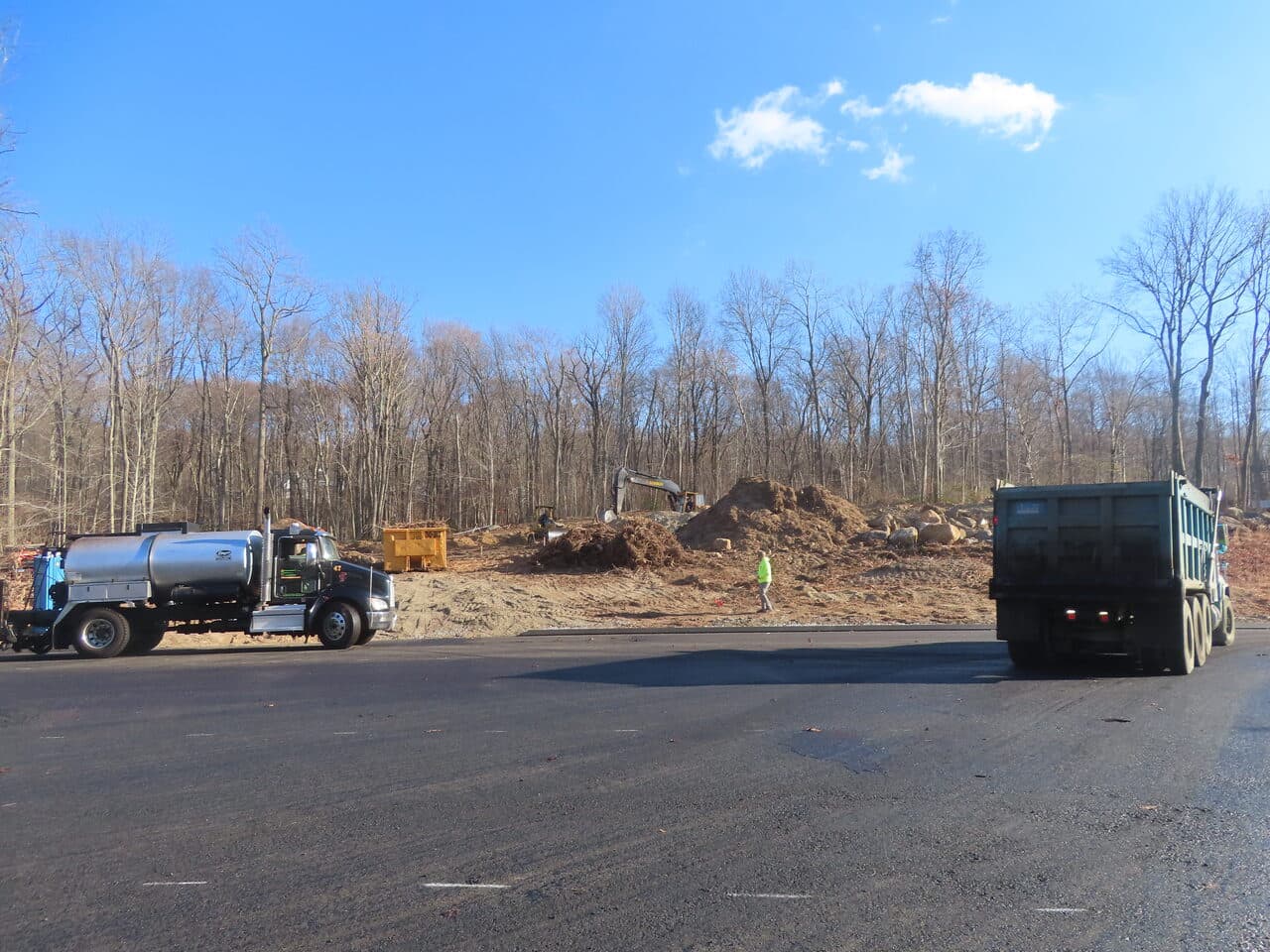 Roadway Paving project in Higganum, CT — trucks at graded dirt site