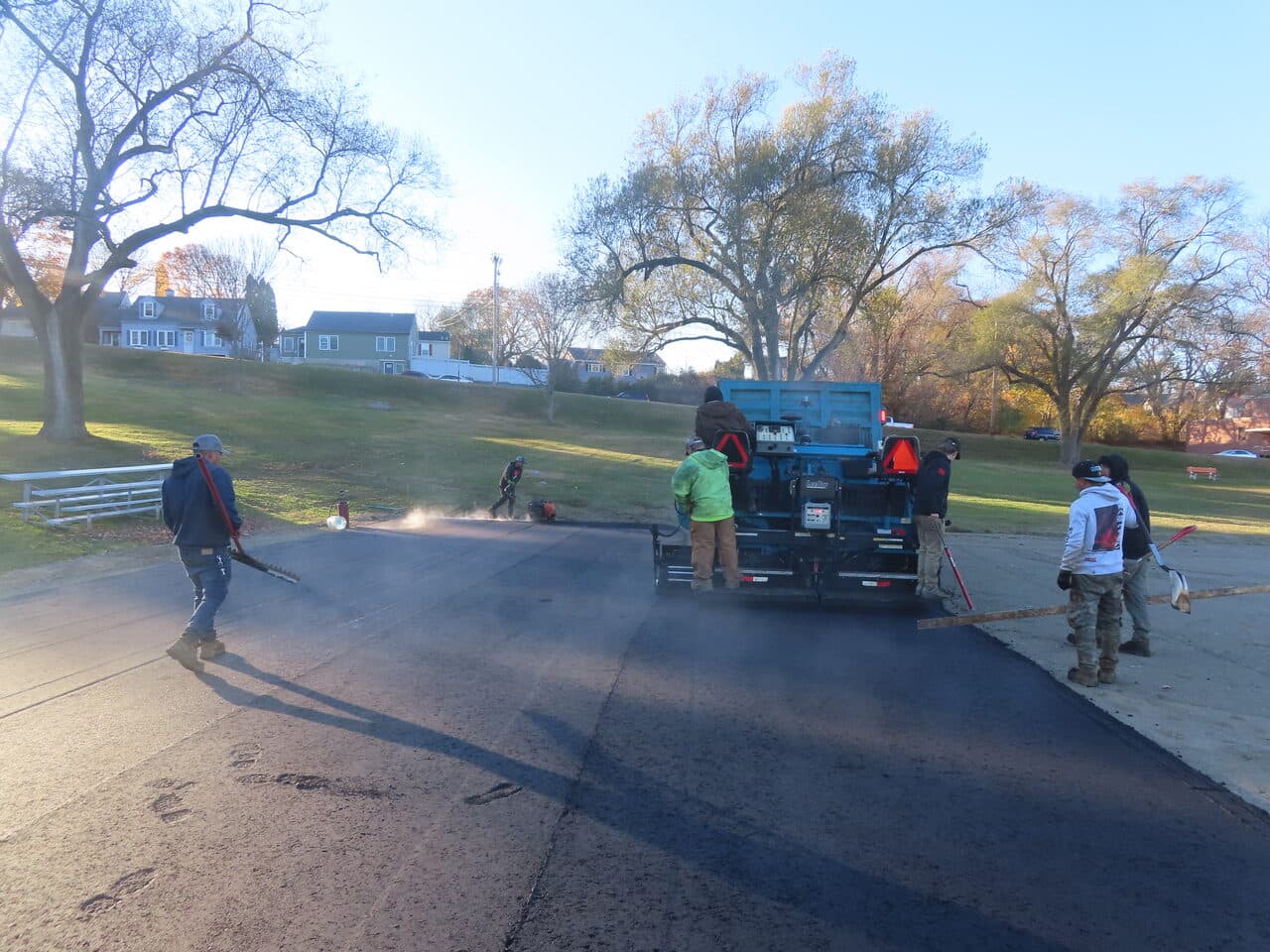 Commercial Parking Lot Paving project in Groton, CT — crew paving lot near houses