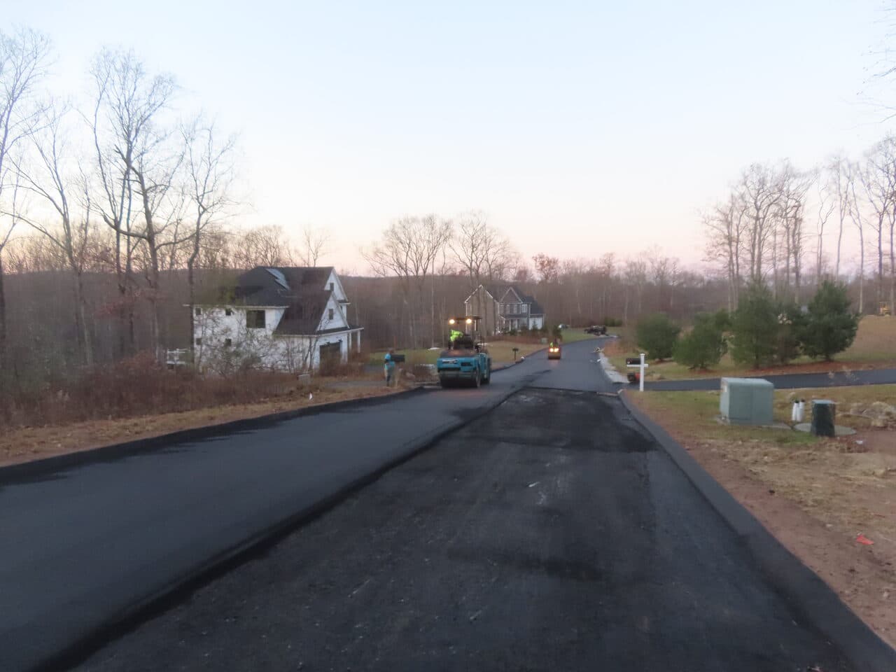 Roadway Paving project in Higganum, CT — fresh paved road with roller