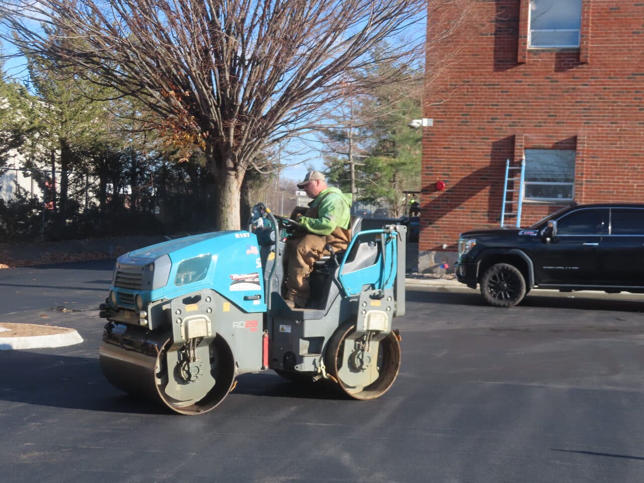 Commercial Parking Lot Paving project in Hartford, CT — roller compacting fresh asphalt lot