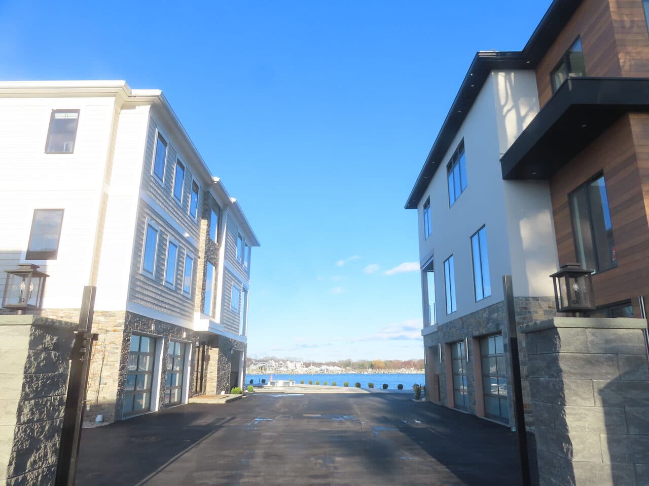 Roadway Paving project in Branford, CT — finished drive between waterfront buildings