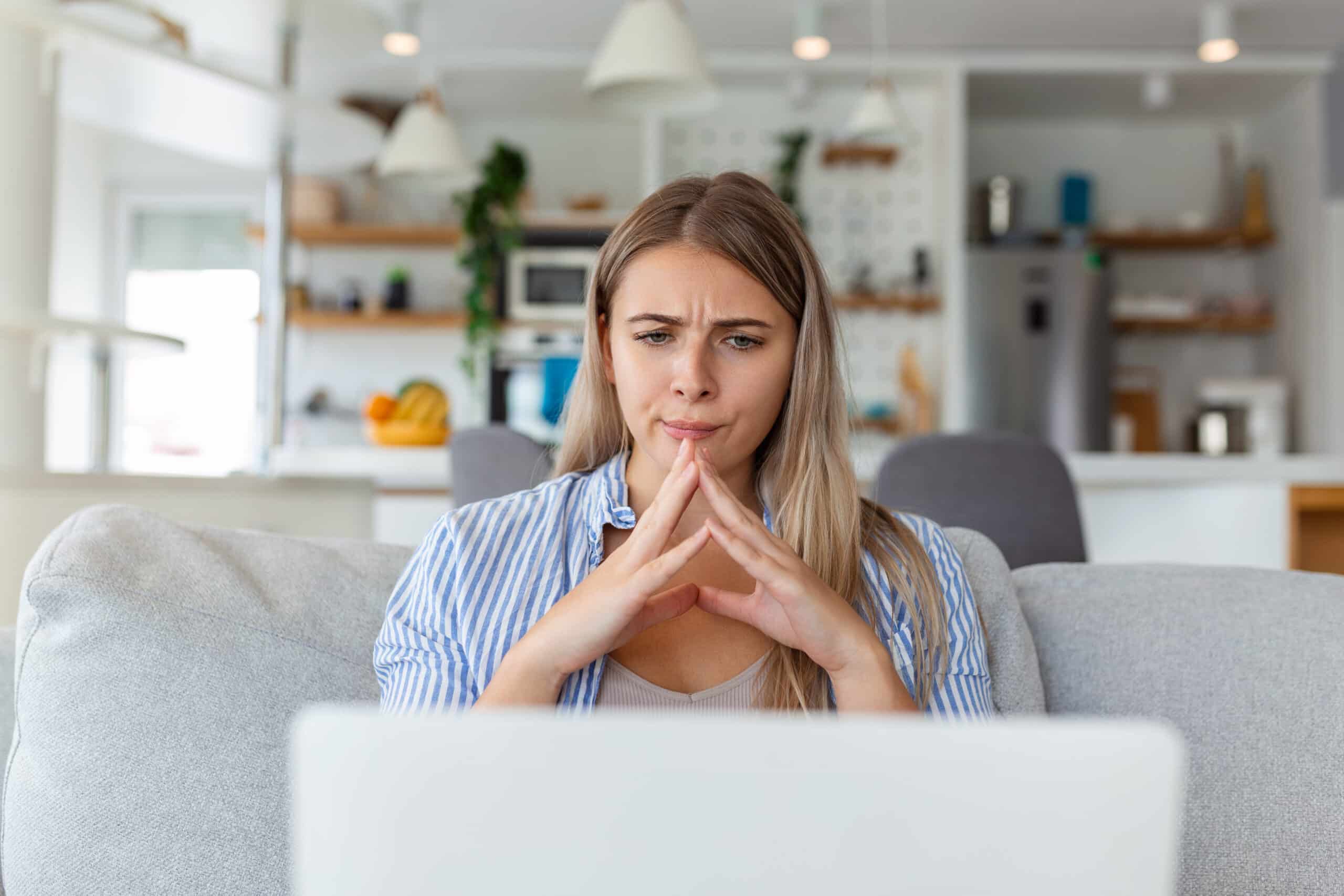 Concerned woman looking at a scam email