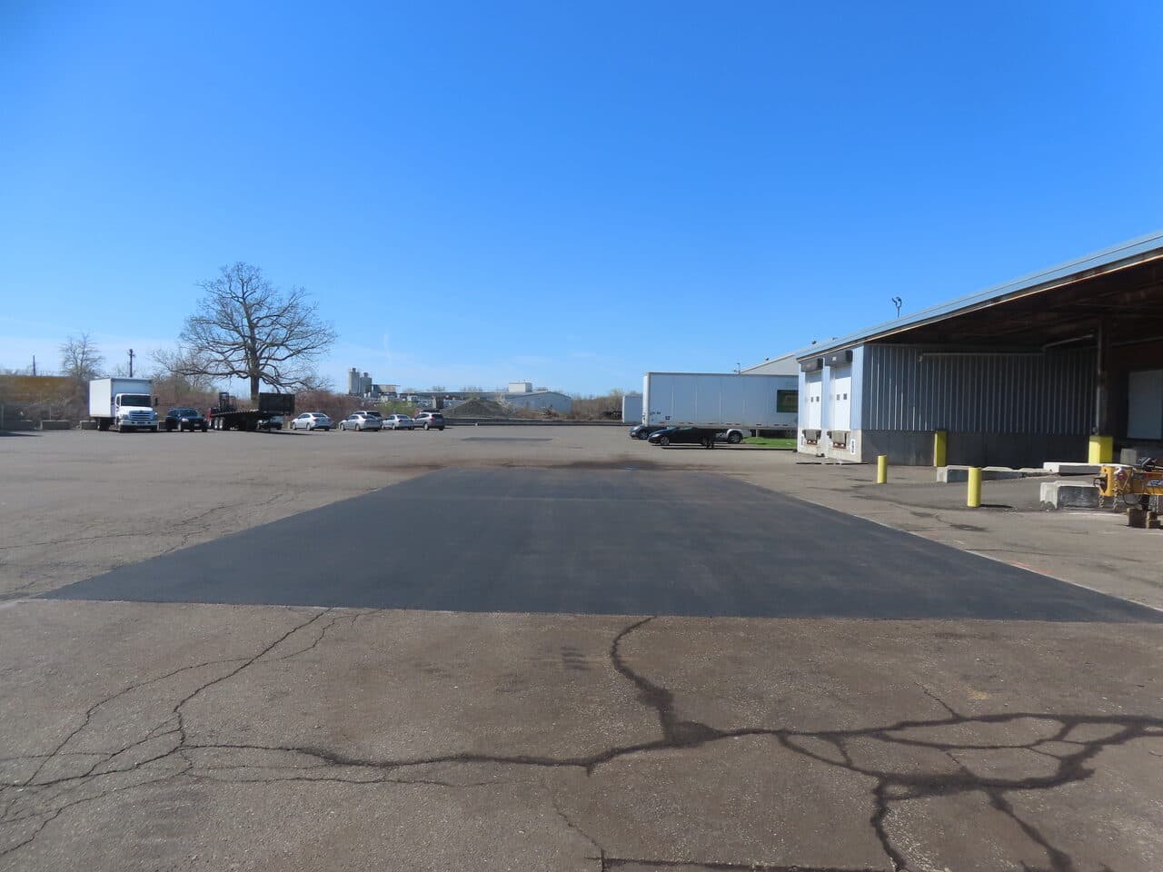 Commercial Parking Lot Repair & Patching project in Northford, CT — fresh asphalt patch in commercial lot
