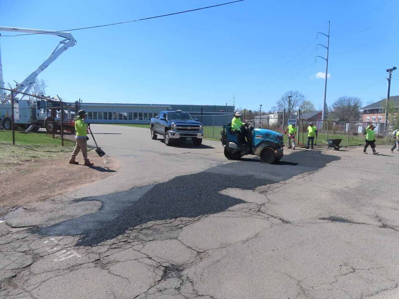 Commercial Parking Lot Repair & Patching project in Northford, CT — roller compacting fresh patch on driveway