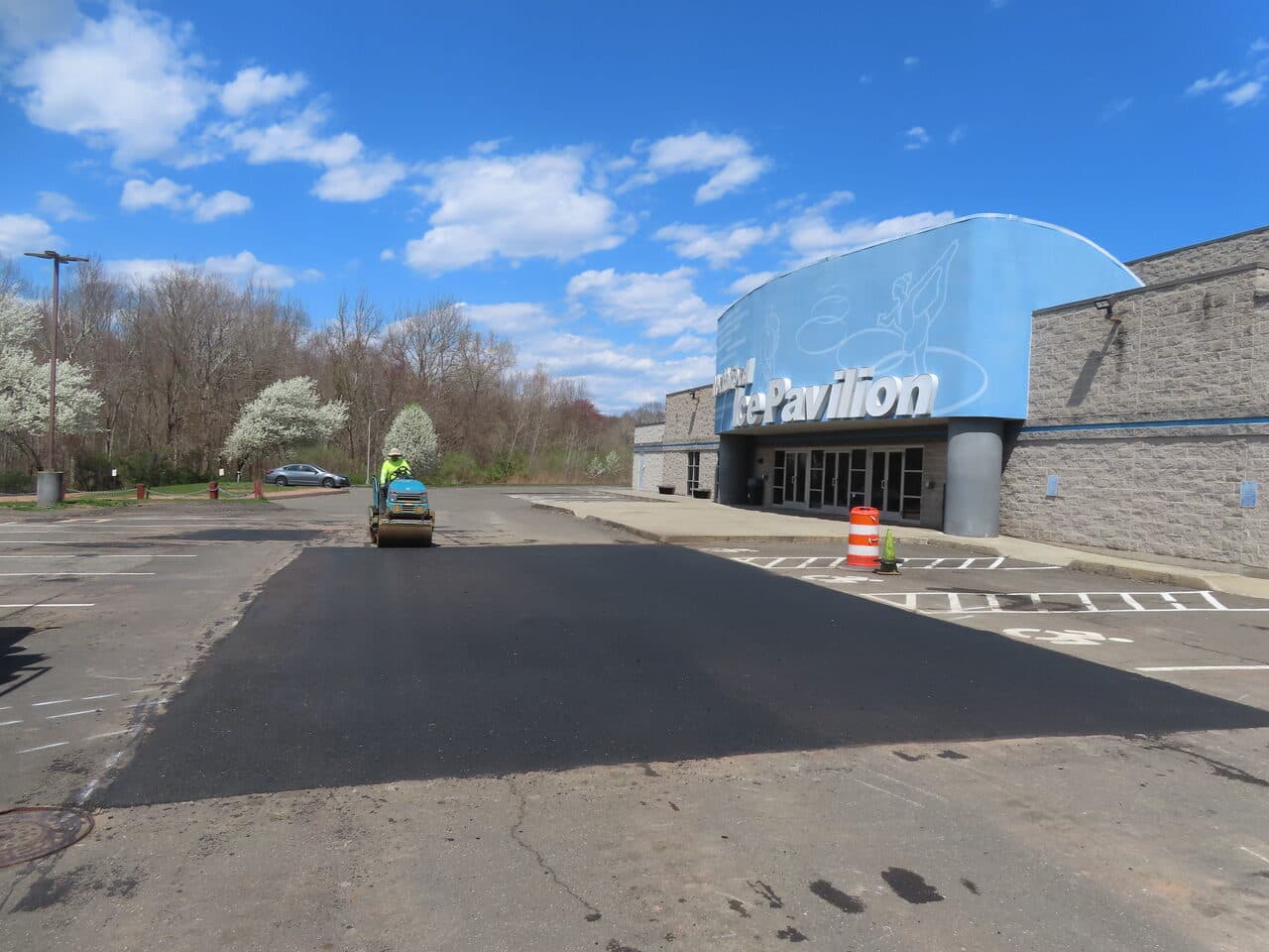 Commercial Parking Lot Repair & Patching project in Northford, CT — roller paving lot at Ice Pavilion