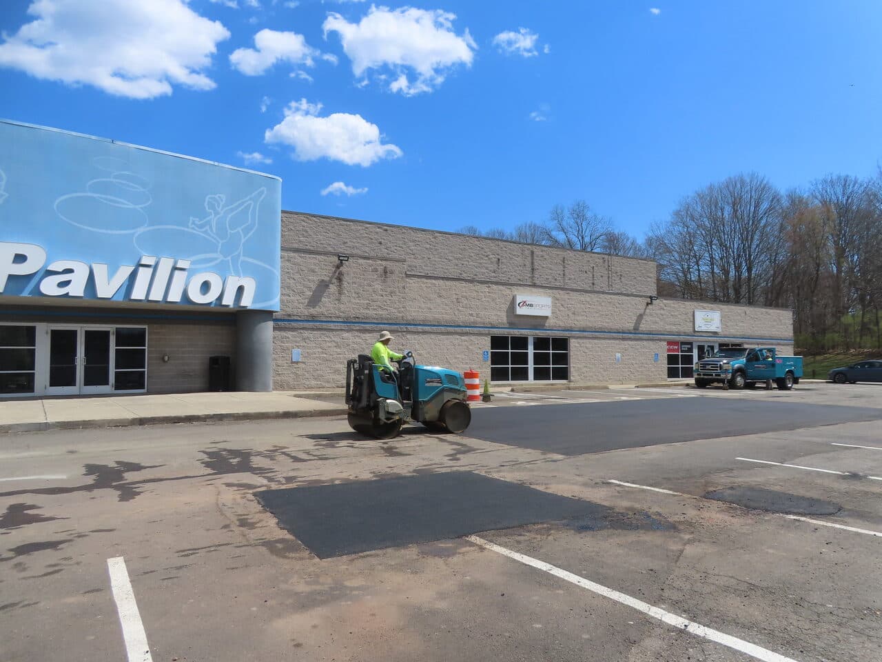 Commercial Parking Lot Repair & Patching project in Northford, CT — roller compacting patch by Pavilion building
