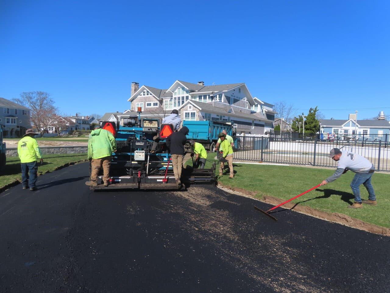 Residential Driveway Paving project in Pine Orchard, CT — paving crew laying asphalt with paver