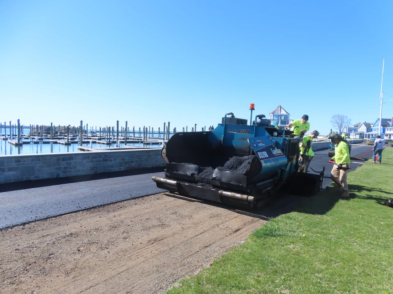 Residential Driveway Paving project in Pine Orchard, CT — LeeBoy paver laying asphalt by marina