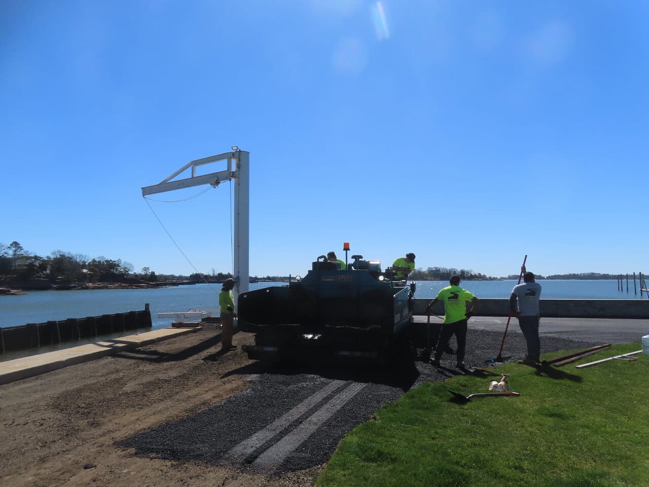 Residential Driveway Paving project in Pine Orchard, CT — crew paving boat ramp area at water