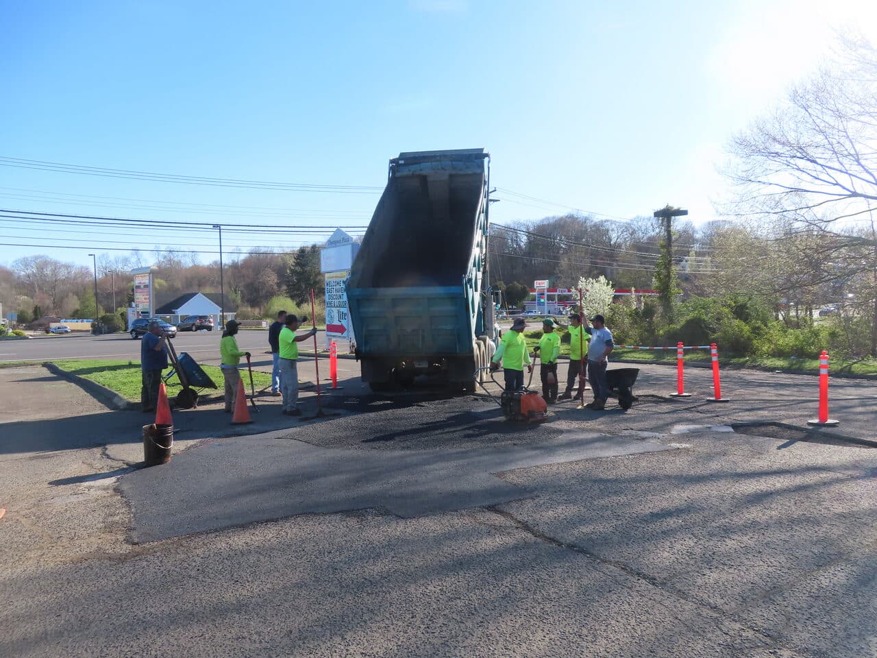 Residential Driveway Paving project in Pine Orchard, CT — crew patching commercial lot by highway