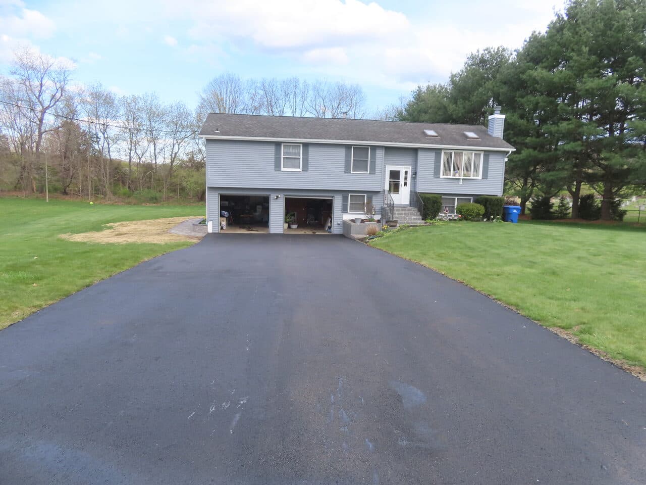 Multi-Stop Residential Driveway Paving project in Wallingford, Branford & Northford, CT — wide fresh driveway at raised ranch