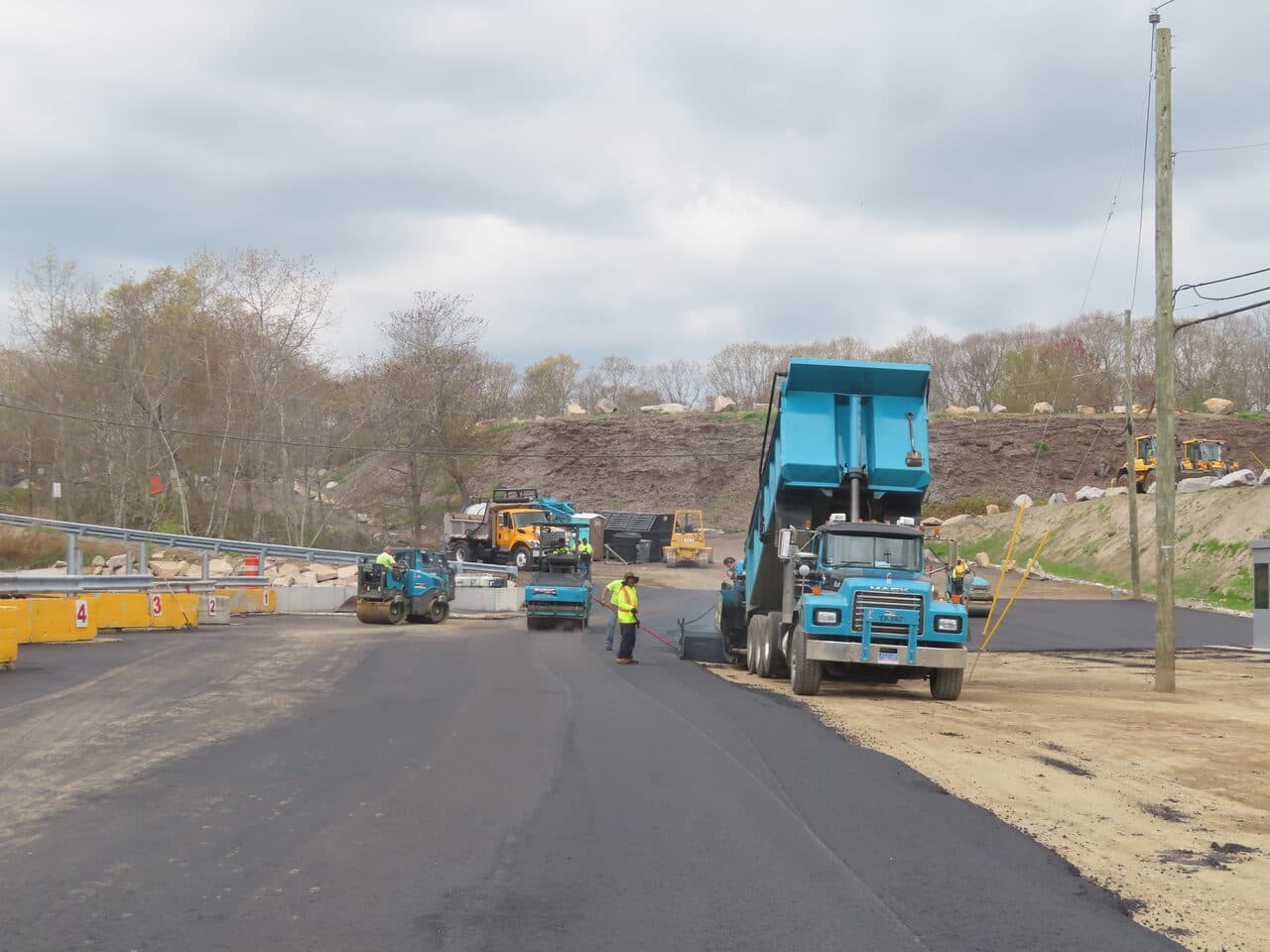 Commercial Parking Lot Paving project in East Lyme, CT — paving crew laying asphalt at transfer station