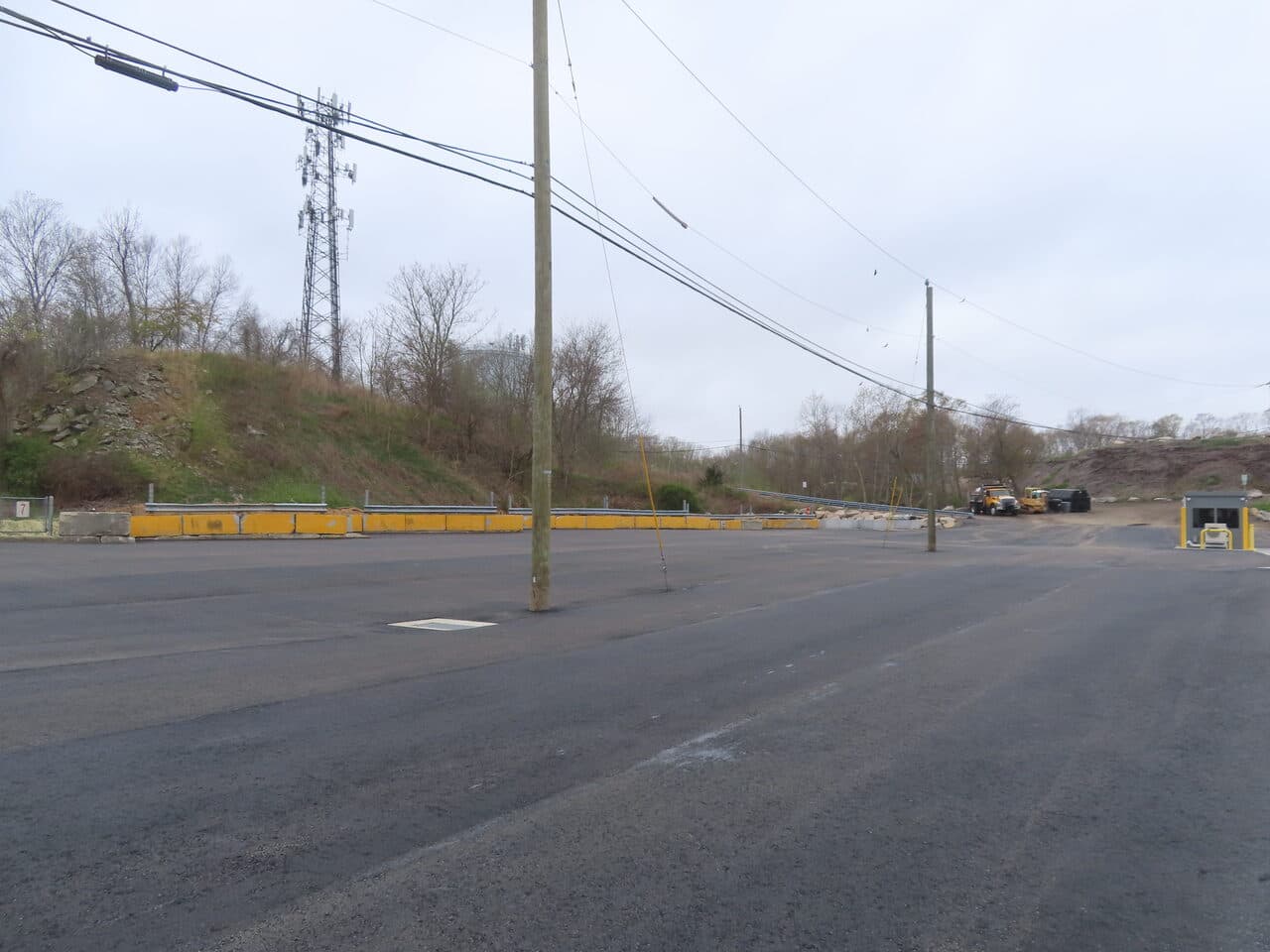 Commercial Parking Lot Paving project in East Lyme, CT — wide finished lot with guardrail