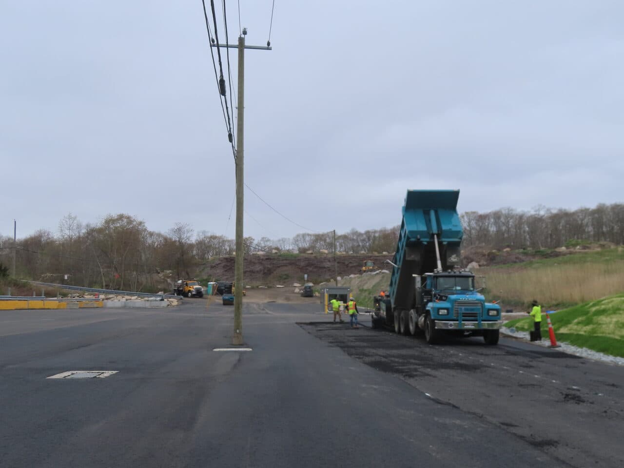 Commercial Parking Lot Paving project in East Lyme, CT — paver laying asphalt with dump truck