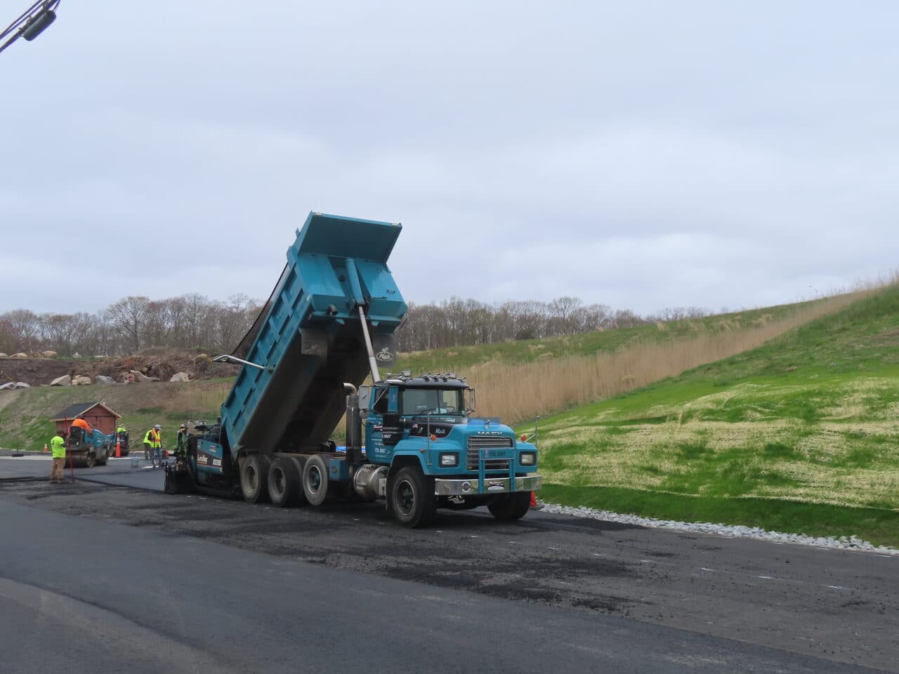 Commercial Parking Lot Paving project in East Lyme, CT — dump truck feeding paver