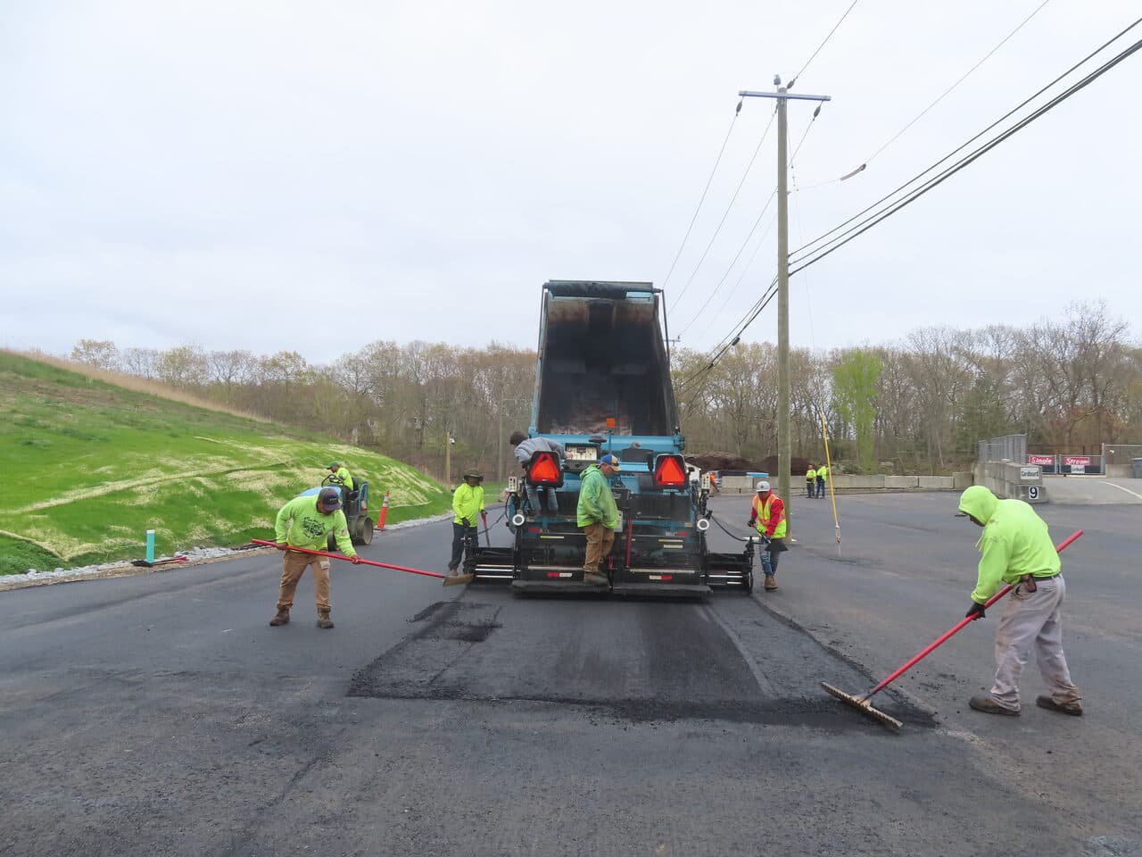 Commercial Parking Lot Paving project in East Lyme, CT — crew finishing asphalt behind paver