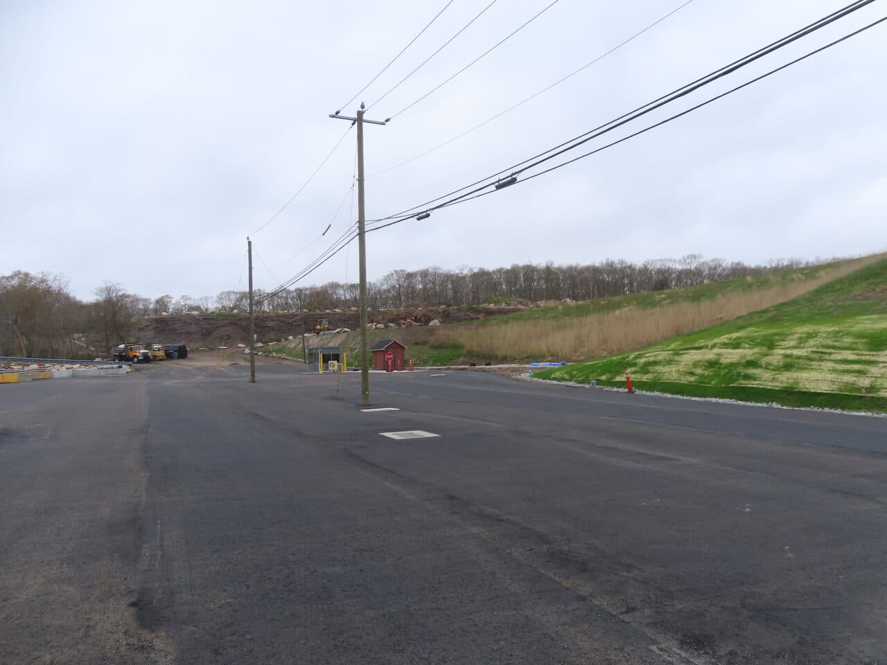 Commercial Parking Lot Paving project in East Lyme, CT — finished asphalt lot with guard booth