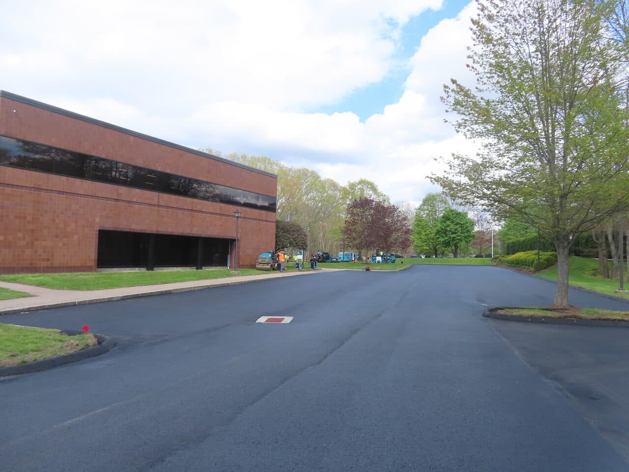 Commercial Sealcoating project in Glastonbury, CT — fresh lot with crew staging area