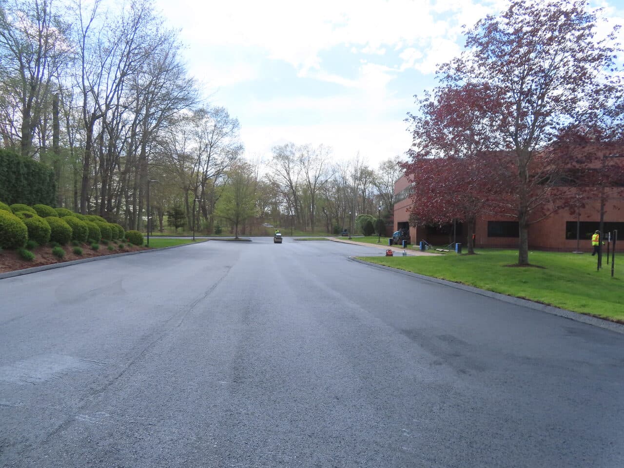 Commercial Sealcoating project in Glastonbury, CT — fresh sealed lot toward building