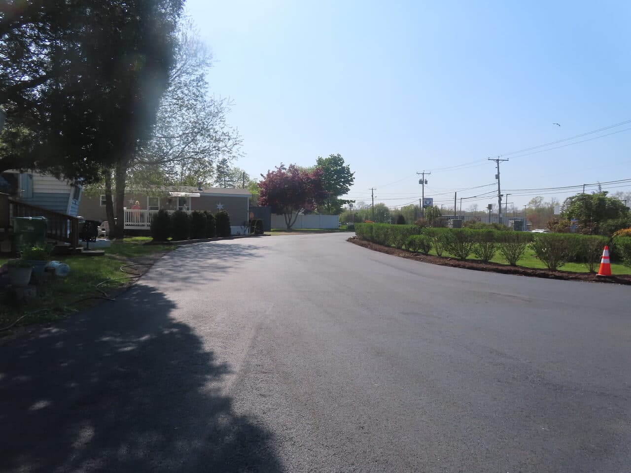 Commercial Parking Lot Paving project in Branford, CT — freshly paved road with landscaping