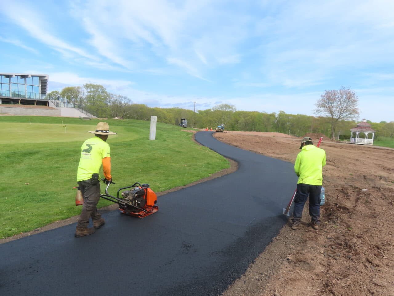 Golf Course Cart Path Paving project in Hamden, CT — crew compacting new asphalt path