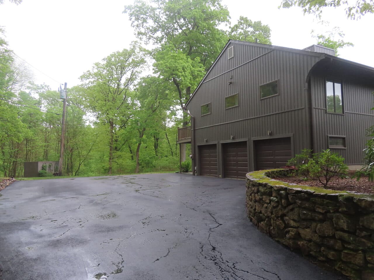Residential Driveway Paving project in Hamden, CT — three-car garage with fresh asphalt apron