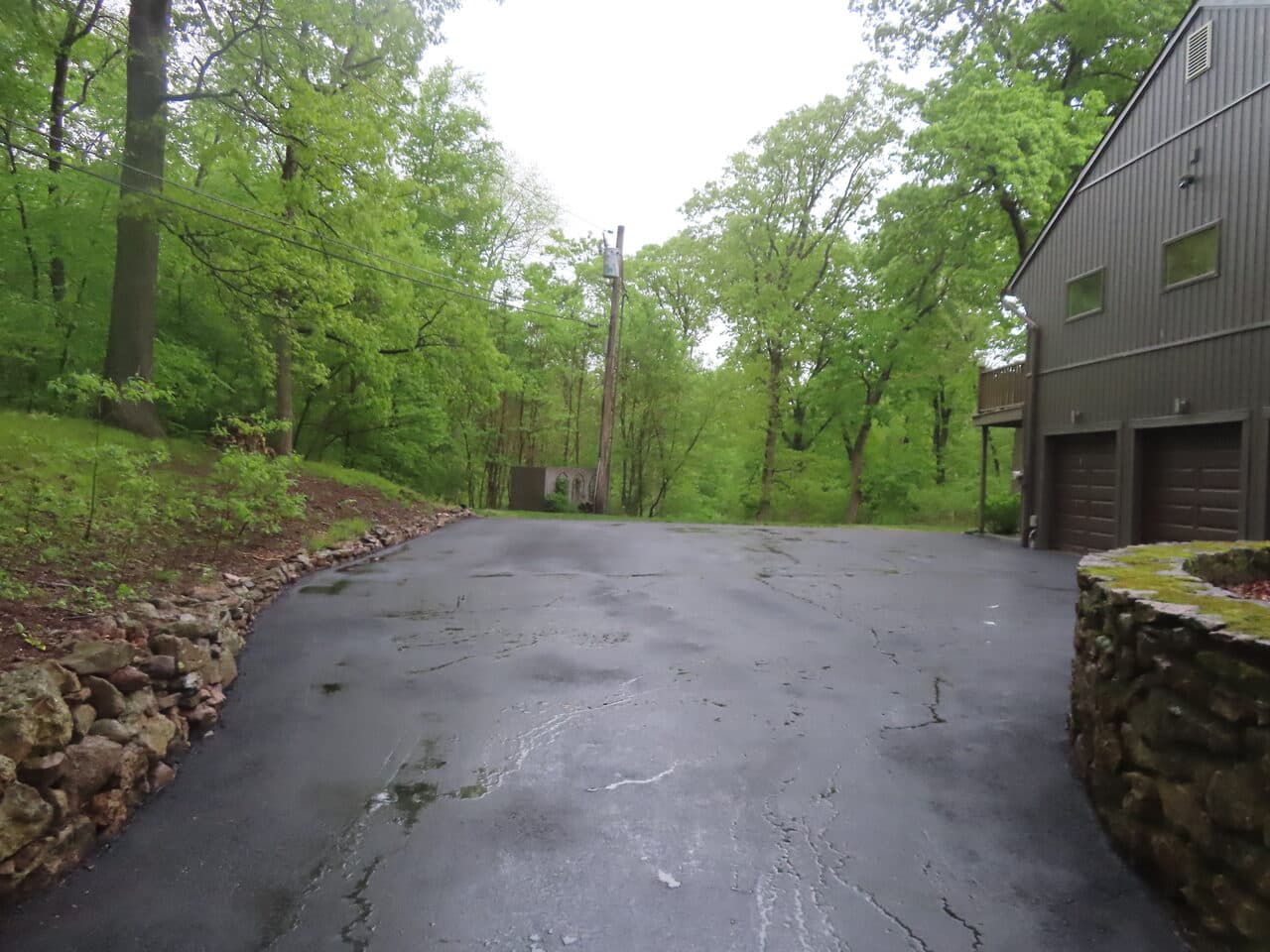 Residential Driveway Paving project in Hamden, CT — wide asphalt drive toward garage