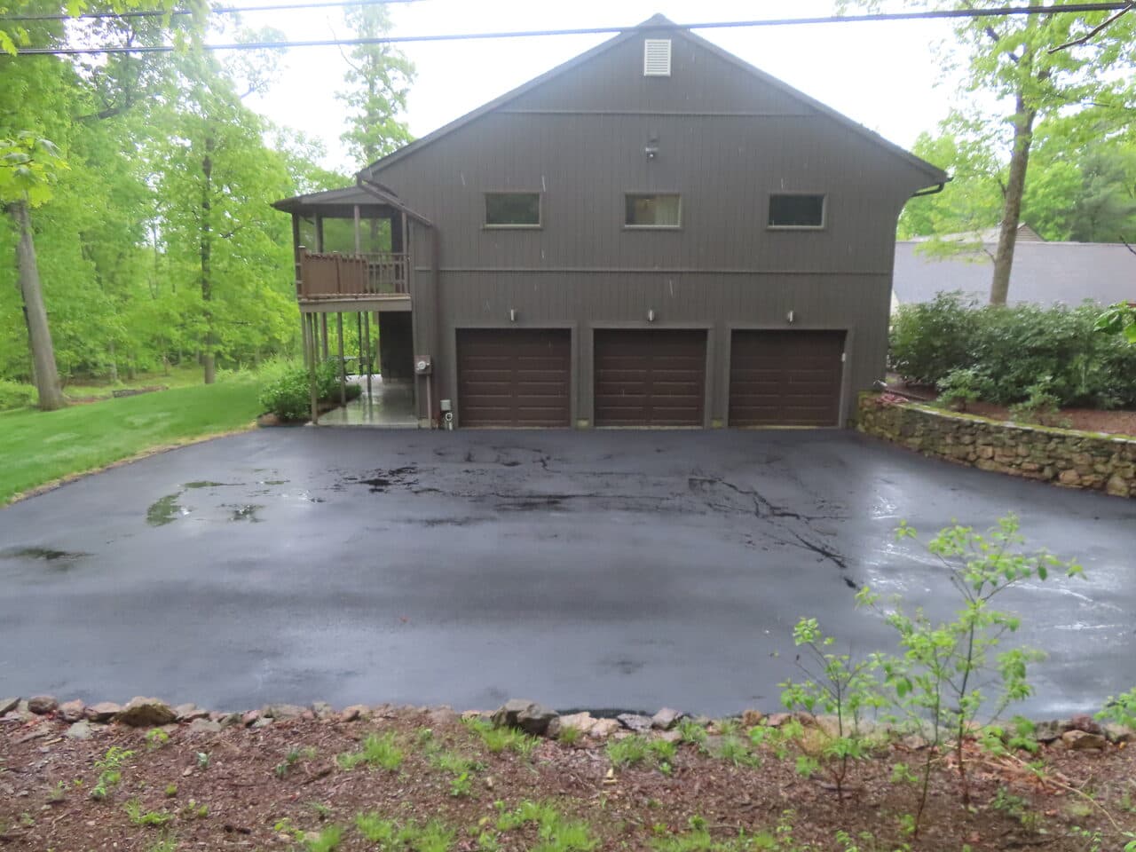 Residential Driveway Paving project in Hamden, CT — fresh driveway in front of garage
