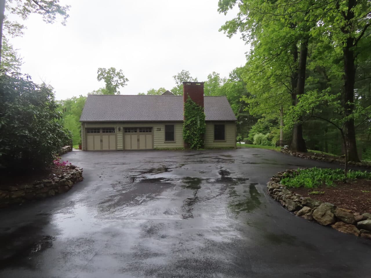 Residential Driveway Paving project in Hamden, CT — wide finished driveway by detached garage