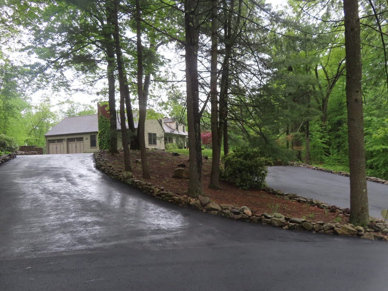 Residential Driveway Paving project in Hamden, CT — tree-lined driveway curve to garage