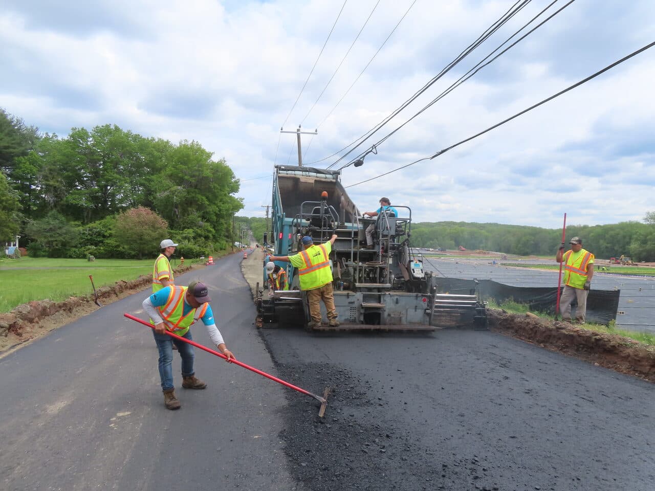 Roadway Paving project in Cheshire, CT — crew raking asphalt behind paver