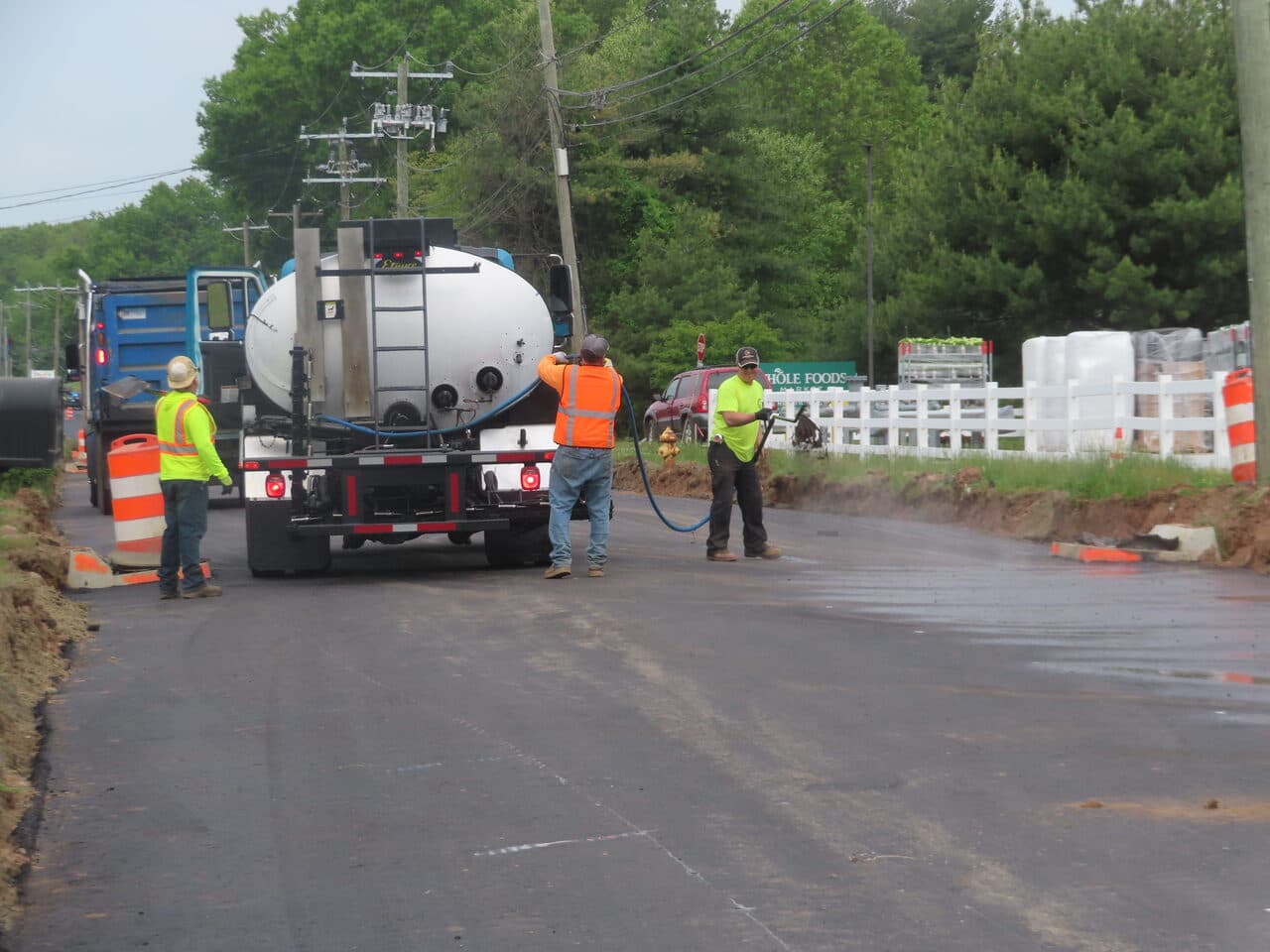 Roadway Paving project in Cheshire, CT — crew tack coat spraying on road