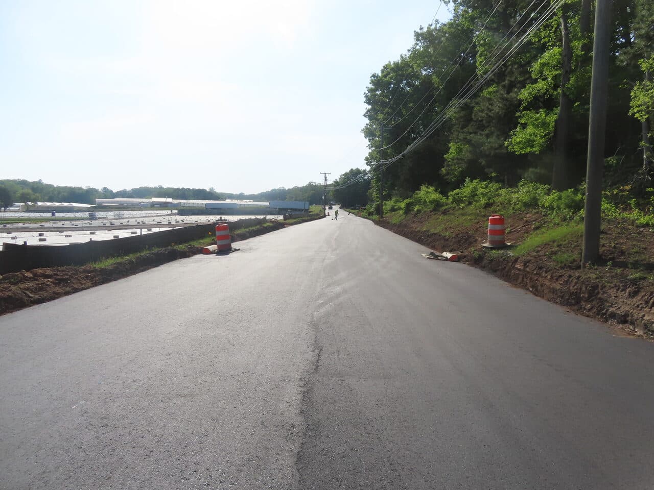 Commercial Night Parking Lot Paving project in Pittsburgh, PA — finished fresh paved road wide shot