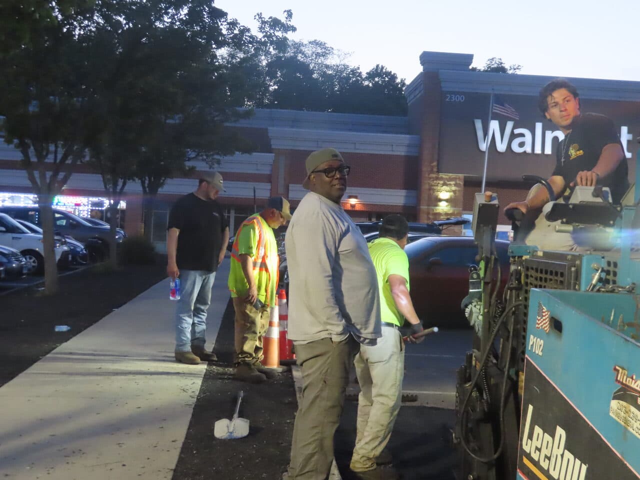 Commercial Night Parking Lot Paving project in Pittsburgh, PA — crew at dusk by Walmart paver