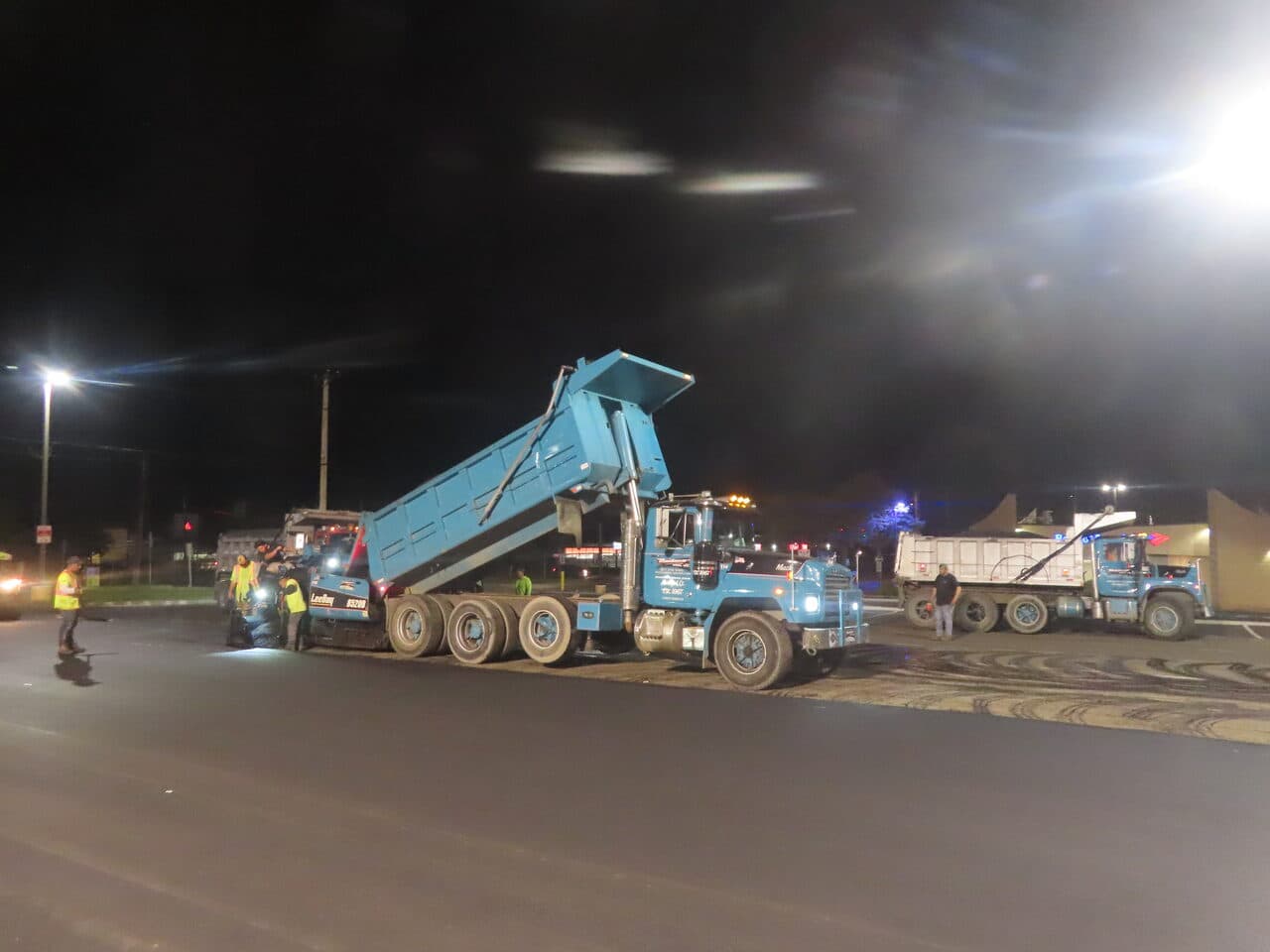 Commercial Night Parking Lot Paving project in Pittsburgh, PA — night paving two dump trucks