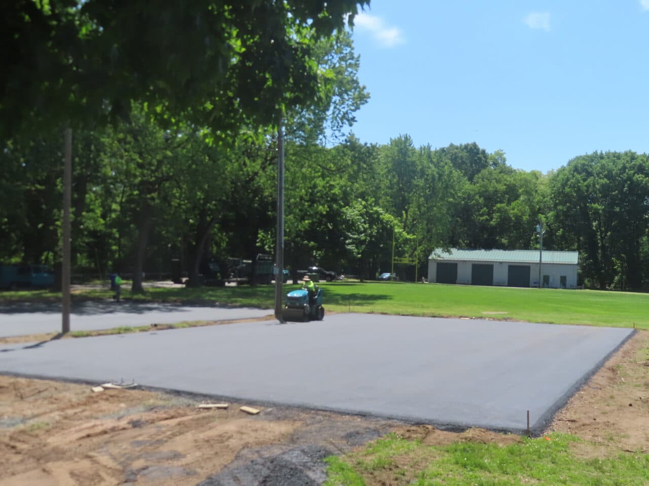 Parking Lot & Athletic Surface Base Paving project in East Hartford, CT — fresh paved lot near building