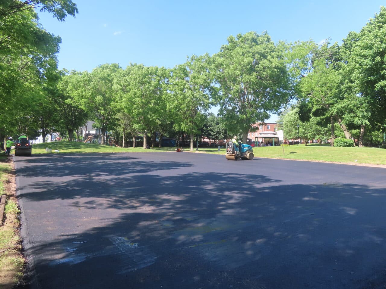 Parking Lot & Athletic Surface Base Paving project in East Hartford, CT — freshly paved roadway with rollers