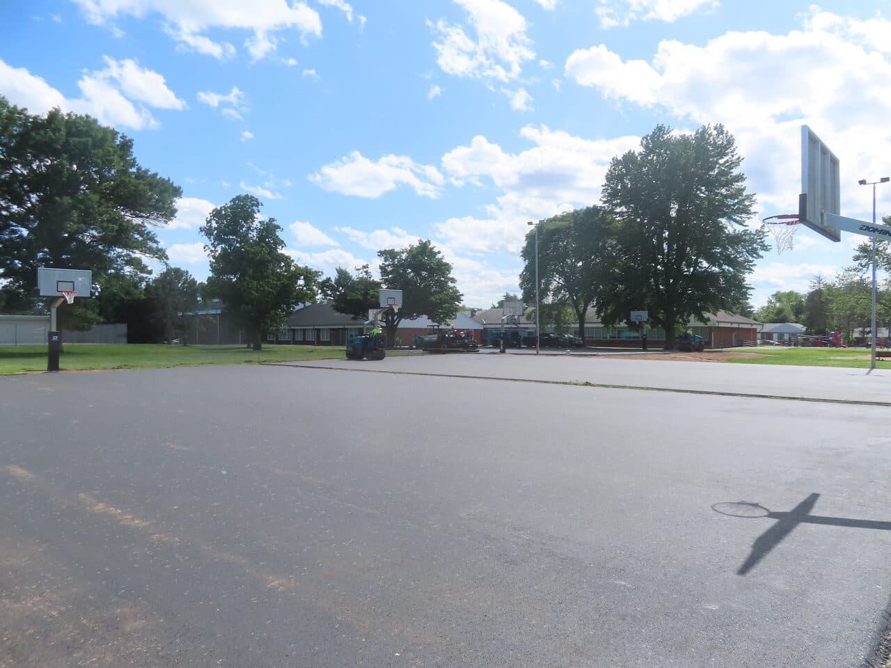 Parking Lot & Athletic Surface Base Paving project in East Hartford, CT — fresh asphalt court with hoops