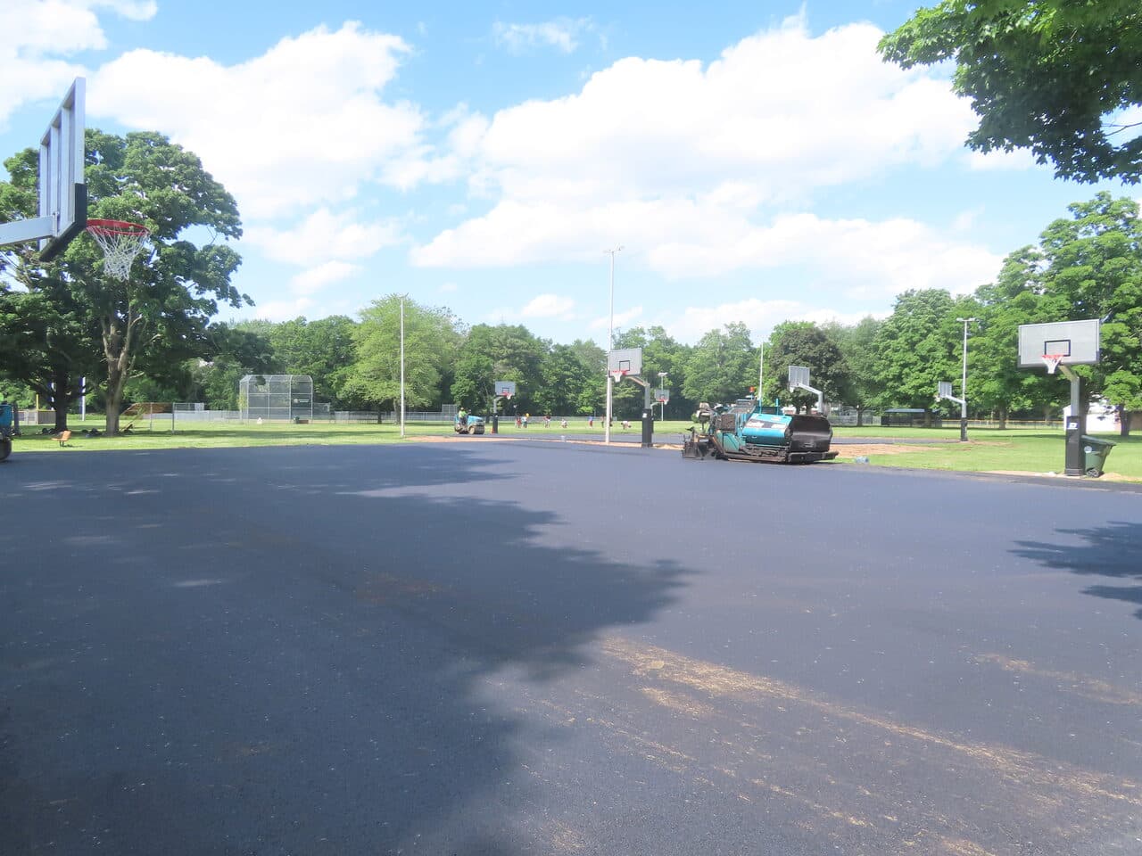 Parking Lot & Athletic Surface Base Paving project in East Hartford, CT — paver finishing fresh asphalt court