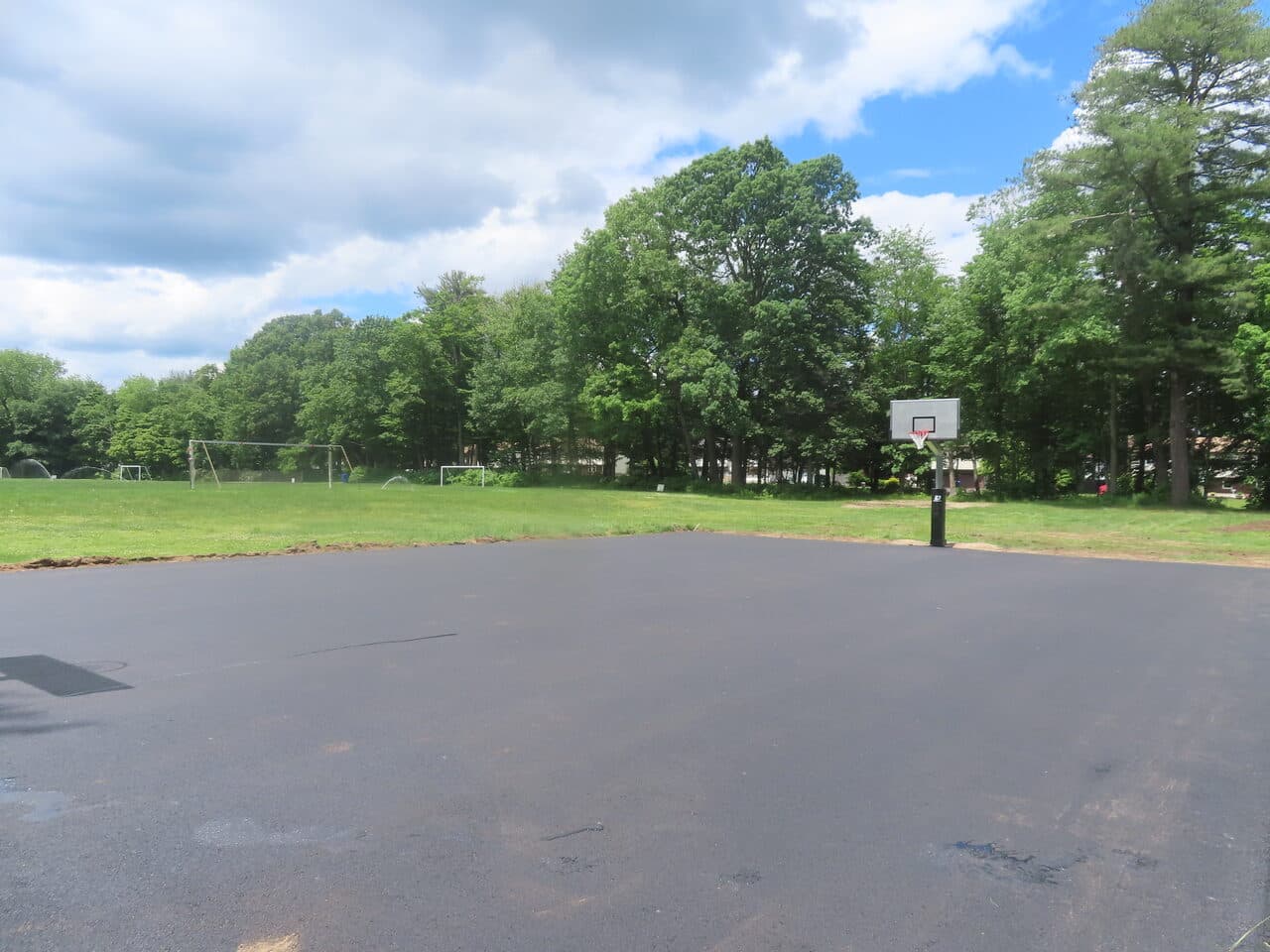 Parking Lot & Athletic Surface Base Paving project in East Hartford, CT — finished asphalt court near fields