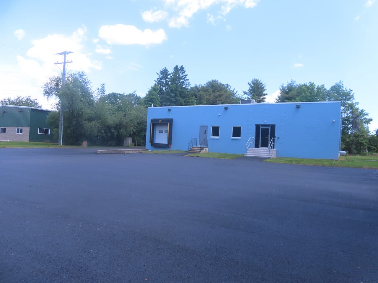 Commercial Parking Lot Paving project in Branford, CT — finished lot at blue loading dock building
