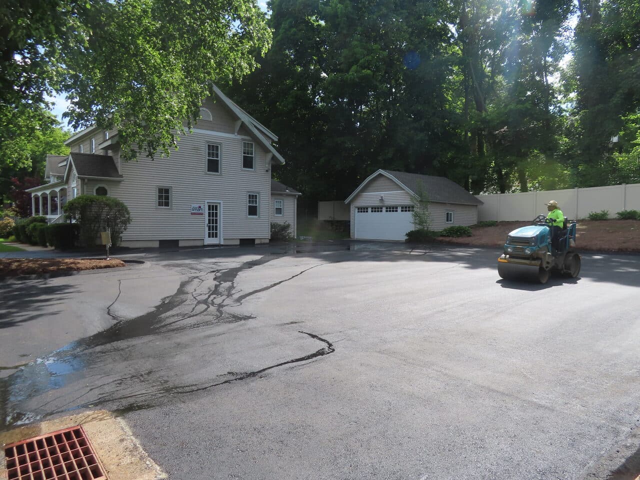 Commercial Driving School Parking Lot Paving project in Hamden, CT — roller compacting residential lot paving