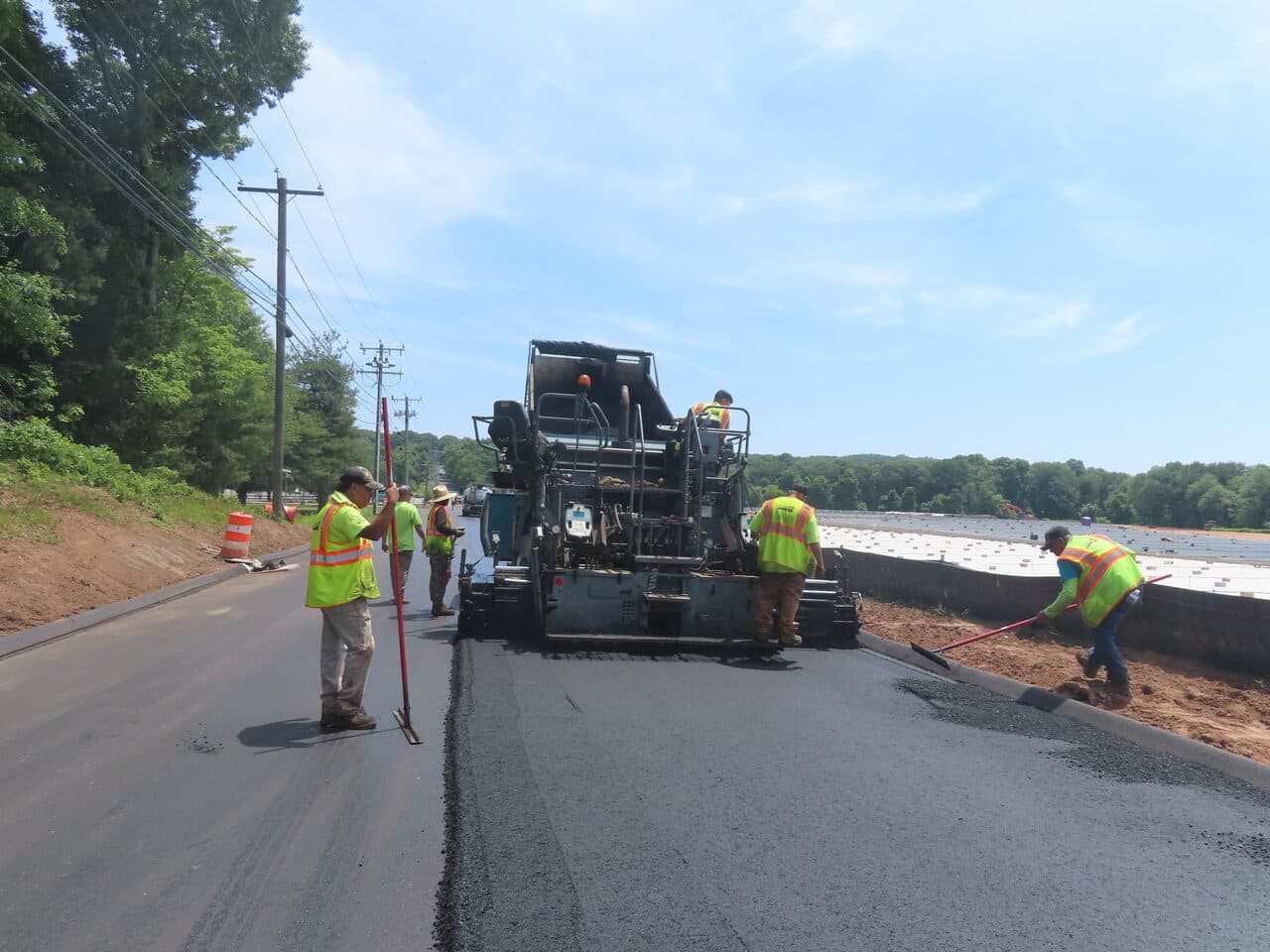Roadway Paving project in Cheshire, CT — crew paving road with paver