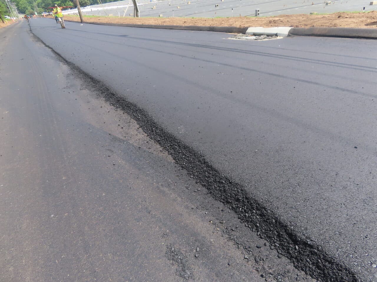 Roadway Paving project in Cheshire, CT — fresh asphalt mat edge and curb