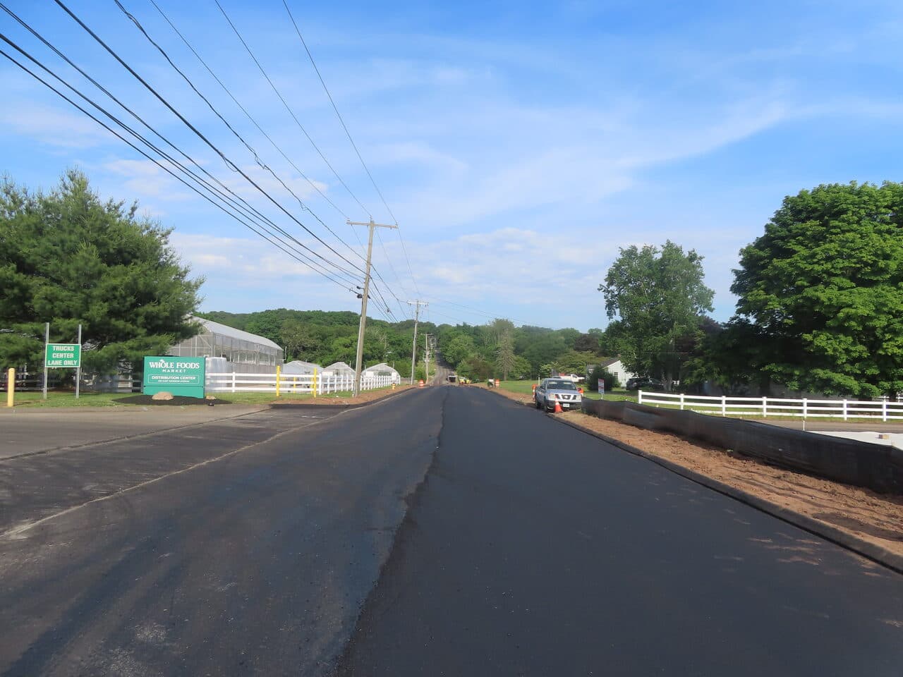 Roadway Paving project in Cheshire, CT — finished road by Whole Foods sign