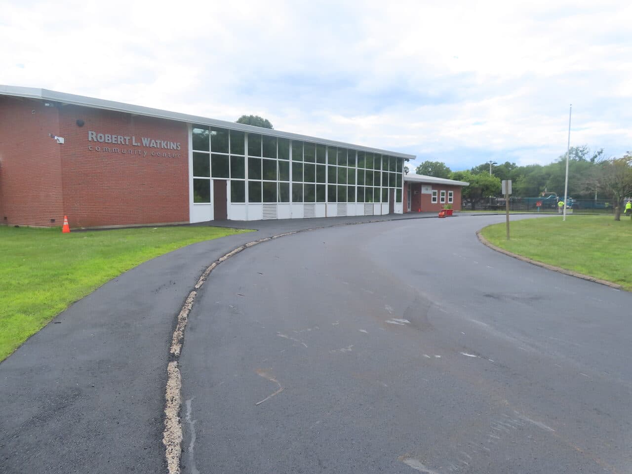 Commercial Parking Lot Paving project in Bloomfield, CT — fresh asphalt drive at Watkins community center