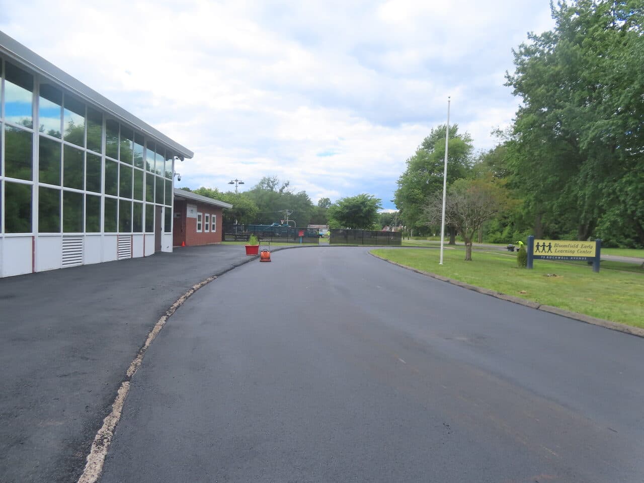 Commercial Parking Lot Paving project in Bloomfield, CT — new asphalt drive by learning center sign