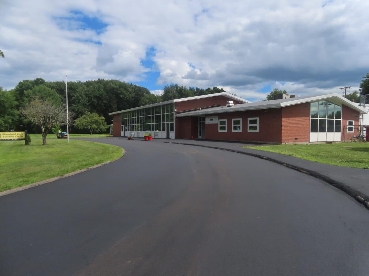 Commercial Parking Lot Paving project in Bloomfield, CT — wide finished asphalt drive and building