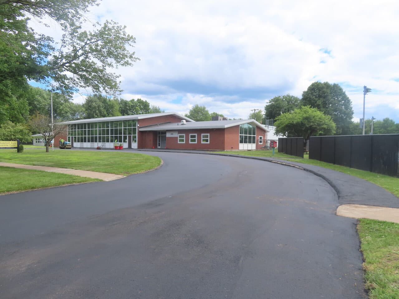Commercial Parking Lot Paving project in Bloomfield, CT — finished asphalt loop drive at center