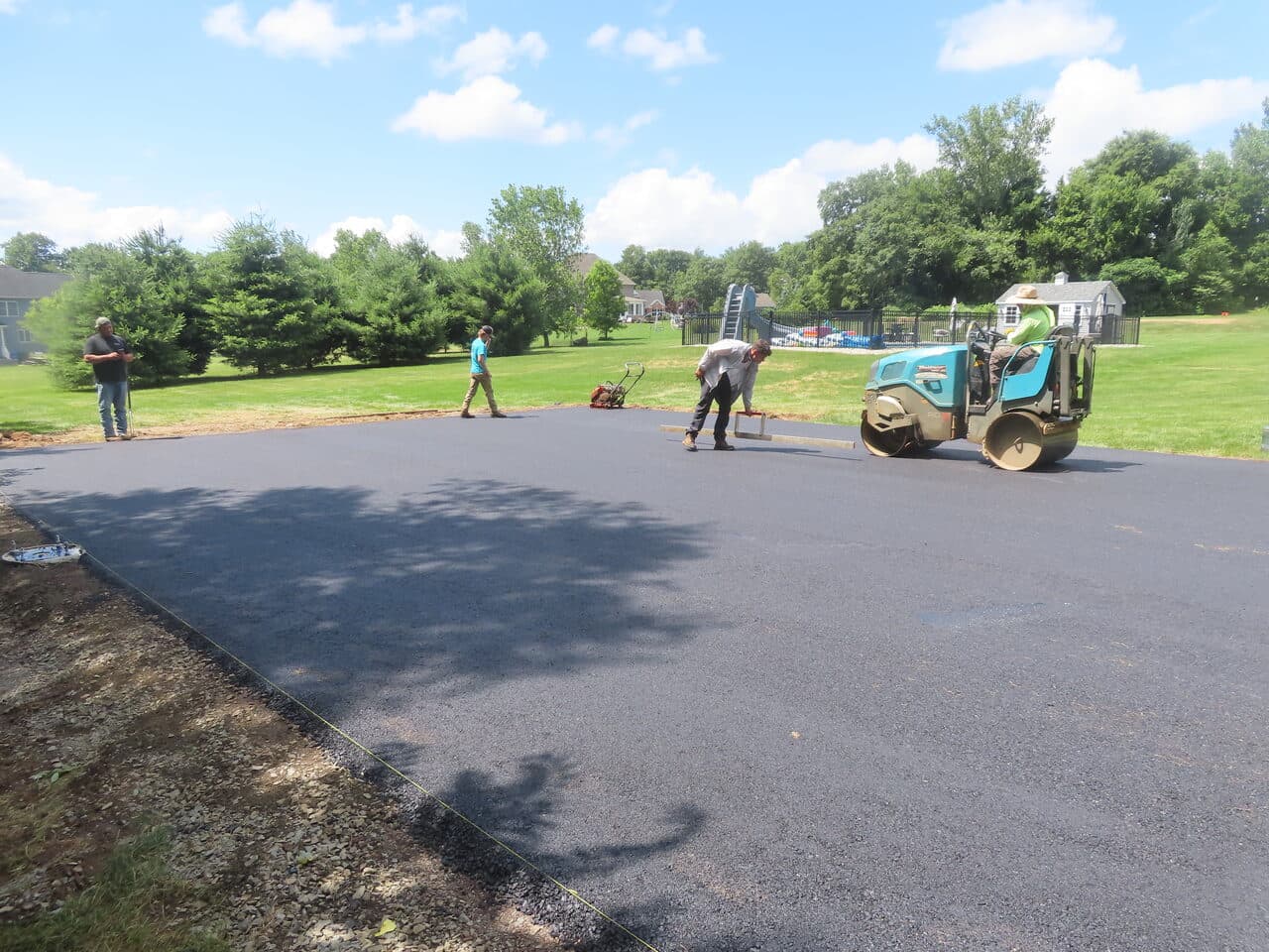 Asphalt Pad Paving project in North Haven, CT — fresh asphalt pad being compacted